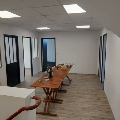 Bureau rénové avec tables en bois et portes noires